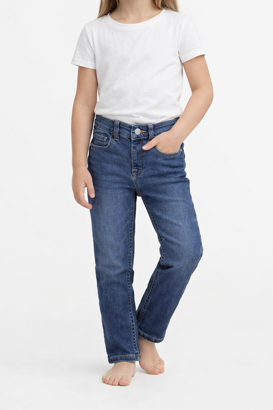 sps-kids-denim-jeans-front-worn-model1 Person wearing blue jeans and a white t-shirt on a white background
